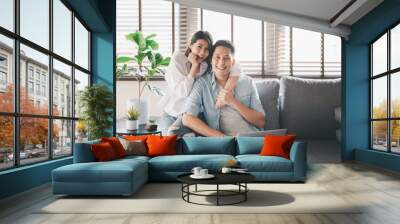 happy Asian couple having a good time at home Wall mural