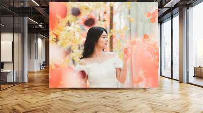 Portrait of happy beautiful Asian woman  in a white dress in autumn. warm sunny weather fall concept Wall mural