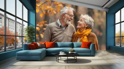 Happy senior couple at the park, close-up portrait of a happy elderly man and woman in love walking together outdoors in autumn nature. Wall mural