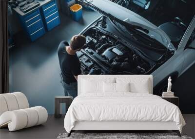 Under the hood. A car mechanic working on the engine of a white car in a modern workshop, car repairs concept, top view. Wall mural