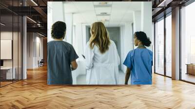 doctor and nurses walking down hallway in hospital Wall mural