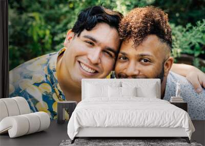 Portrait of smiling happy gay men hugging in garden Wall mural