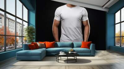 A muscular male model wearing a plain white t-shirt with a black background; a mockup white t-shirt worn by a white male model; graphic resources; mockup photography Wall mural