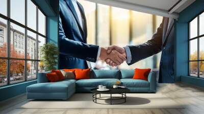 Business people shaking hands in office; closeup view of two man shaking hands; blurred background; professional office setting; business handling Wall mural