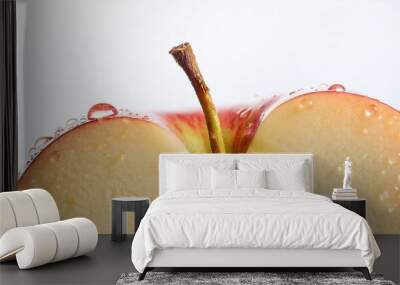 Detailed close-up of cut apple with drops of juice on a white table; selective focus; white background; food photography; fruit photography; healthy and nutritious fruit and ingredient; fresh apple Wall mural