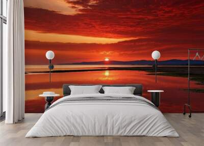 Breathtaking sunset over water with red sky and clouds reflection Wall mural