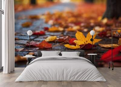 Close up of fallen autumn leaves on cobblestone path highlighting vibrant colors and textures of season Wall mural