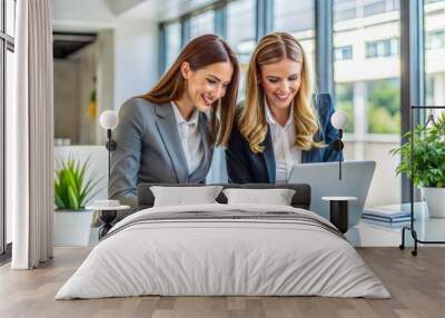 Two businesswomen collaborating in modern office with greenery Wall mural