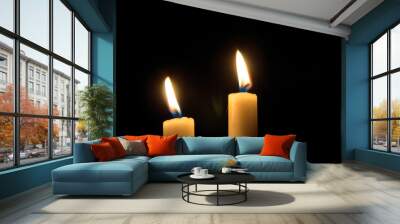 Two burning candles on black background. Copyspace Wall mural