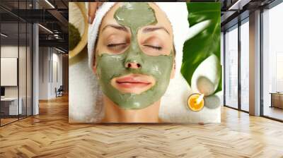 from above a beautiful young woman is enjoying a spirulina or green tea mask treatment in a calming spa atmosphere Wall mural