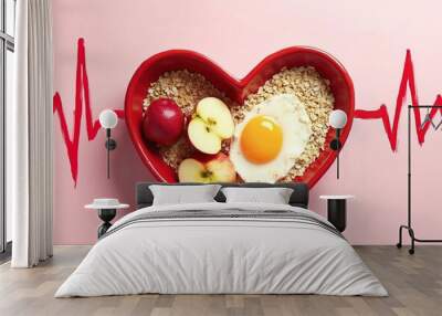 A red heart-shaped dish filled with healthy foods like oats, apples, and eggs, with a red heart rate monitor line in the background, suggesting a healthy lifestyle and heart health concept Wall mural