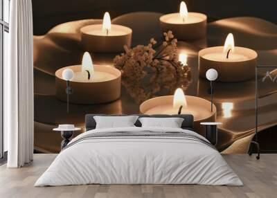 A serene setting with five tealight candles placed on a reflective surface Wall mural