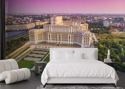 Parliament building or People's House in Bucharest city. Aerial view at sunset with abstract pink sky Wall mural