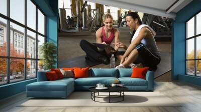 adult female with personal trainer at gym. Wall mural