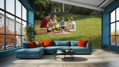 Family having picnic in park. Wall mural