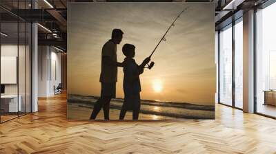 Man and young boy fishing in surf. Wall mural