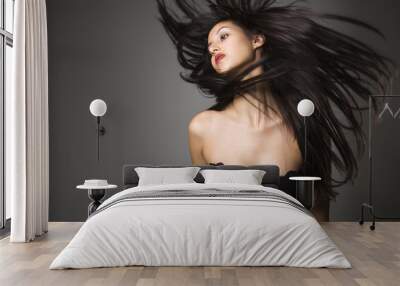 Woman flinging long hair. Wall mural