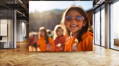 a girl wearing sunglasses and smiling Wall mural