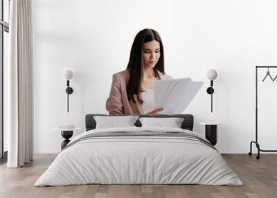 Brunette Asian businesswoman in suit holds sheet of papers looks at documents stands against transparent background. Successful lawyer explores issue at office. Financial bill. Wall mural