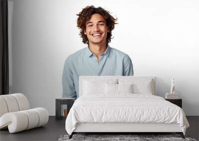 Charming young man with curly hair, wearing a light blue shirt, radiates confidence and friendliness against a transparent background Wall mural