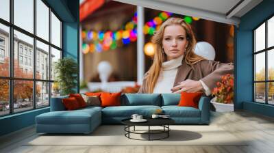 Redhead young adult upset woman standing outside in despair against cafe after break up with husband. Dissapointed caucasian businesswoman in coat and sweater sad after failure, troubles. Frustration. Wall mural