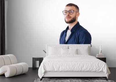 Thoughtful man with glasses writing in a notebook, deep in concentration. Wearing casual attire, he stands isolated on a transparent background Wall mural