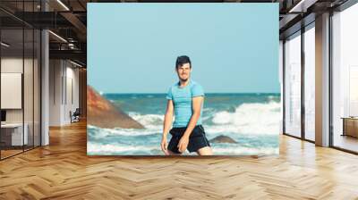 happy family on beach playing, father with son walking sea coast, rocks behind smiling taking vacation Wall mural