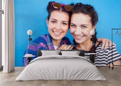 lifestyle people concept: two pretty young school teenage girls having fun happy smiling on blue background Wall mural