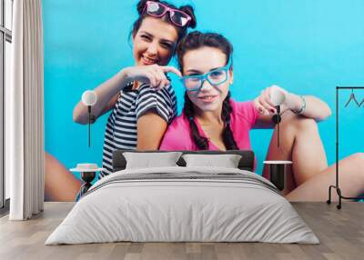 lifestyle people concept: two pretty young school teenage girls having fun happy smiling on blue background Wall mural