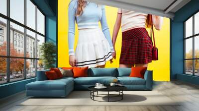 lifestyle people concept: two pretty young school teenage girls having fun happy smiling on yellow background Wall mural