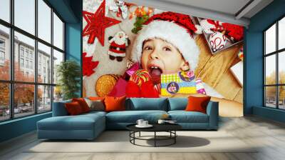 little cute kid in santas red hat with handmade gifts, toys vint Wall mural