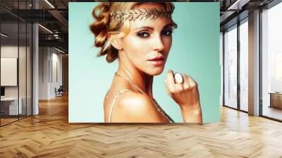 young blond woman dressed like ancient greek godess, gold jewelry close up isolated, beautiful girl hands manicured red nails Wall mural