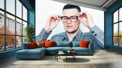 young handsome teenage hipster guy posing emotional wearing glasses, happy smiling lifestyle people concept Wall mural