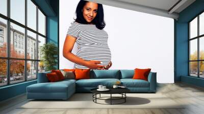 young pretty african american woman pregnant happy smiling, posing on white background isolated , lifestyle people concept copyspace close up Wall mural