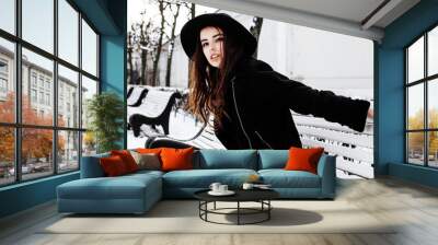 young pretty modern hipster girl waiting on bench at winter snow park alone, lifestyle people concept Wall mural