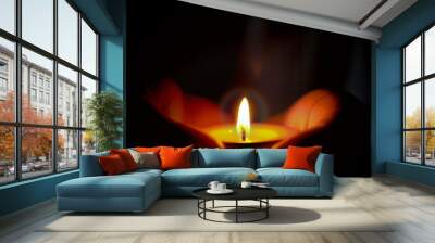 Prayer and hope concept of candle light in hands Wall mural