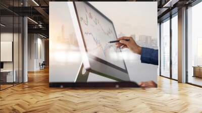 Businessman and pen in hand analyzing sales data and economic growth graph on computer screen. Business strategy, stock market, Digital marketing. Wall mural