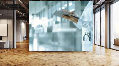 Healthcare and medicine. Medical and technology. Doctor working on digital tablet on hospital background Wall mural