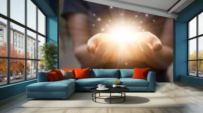 Stardust and magic in woman hands on dark background Wall mural