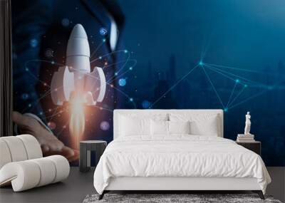 startup business concept, businessman control white rocket is launching and soar flying out from han Wall mural