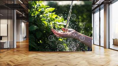 Water pouring in woman hand with icons energy sources for renewable, sustainable development. Ecology concept on nature green leaf background. Earth day. Environment issues Wall mural