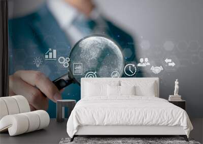 A businessman using a magnifying glass. Business global internet connection application technology and digital marketing, finance and banking, digital link technology, and big data. Wall mural