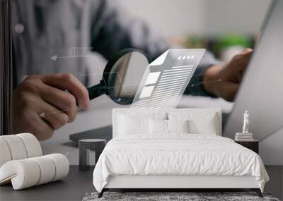 Man inspecting paperwork with magnifier. A business analysis concept. Wall mural