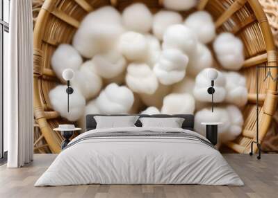 A close-up of a bamboo basket filled with fluffy white cotton Wall mural