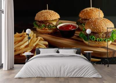 Two burgers, fries with ketchup on wooden board, dark background, food photography Wall mural