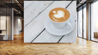 White big cup of coffee with shaped heart art on white wooden table with copy space. Wall mural