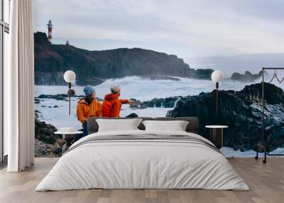 Loving couple admiring the ocean at sunset in the Canary Islands, Spain Wall mural