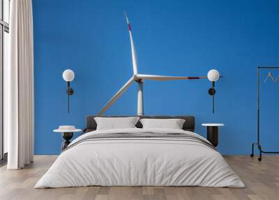 Wind turbine for electricity generation, renewable energy on a blue sky background Wall mural