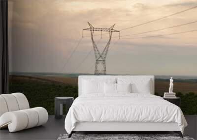 High voltage tower in the fields at sunset Wall mural