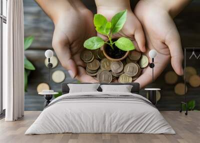 Hands Holding a Sapling and Coins on a Wooden Surface Wall mural